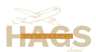 orange background logo two sapphic hags travel.webp